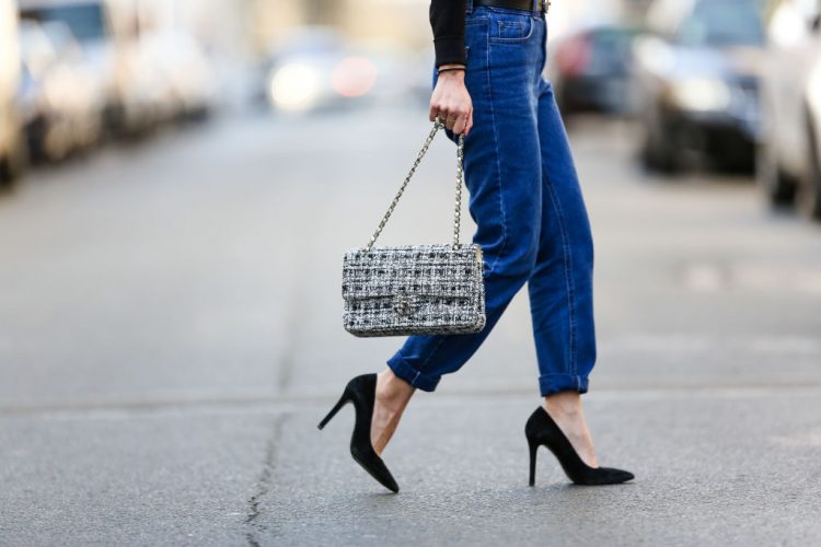 PARIS, FRANCE - FEBRUARY 19:  May Berthelot, Head of Legal at Videdressing.com and fashion blogger, wears an Ivy Revel black low neck top, an Ivy Revel black choker, Newlook mom blue denim jeans pants, Bash heels, a Gucci GG belt, and a Chanel tweed Timeless white bag, on February 19, 2017 in Paris, France.  (Photo by Edward Berthelot/Getty Images)
